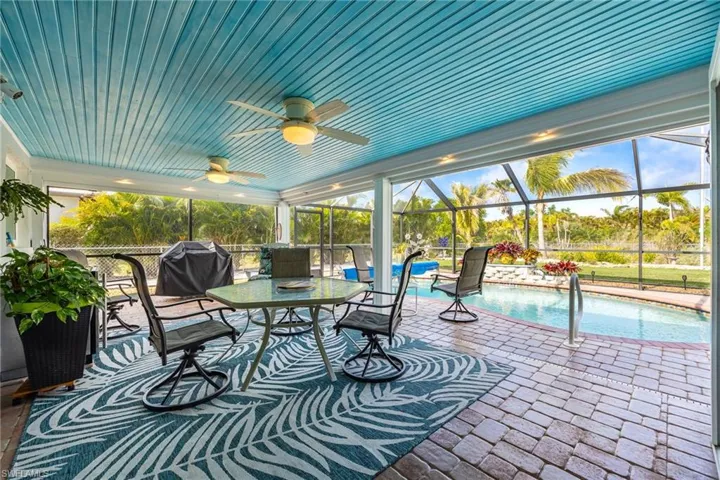 Expansive Paver Lanai  with motorized hurricane screens & a fantastic pool