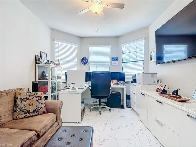 Office space with ceiling fan and a textured ceiling