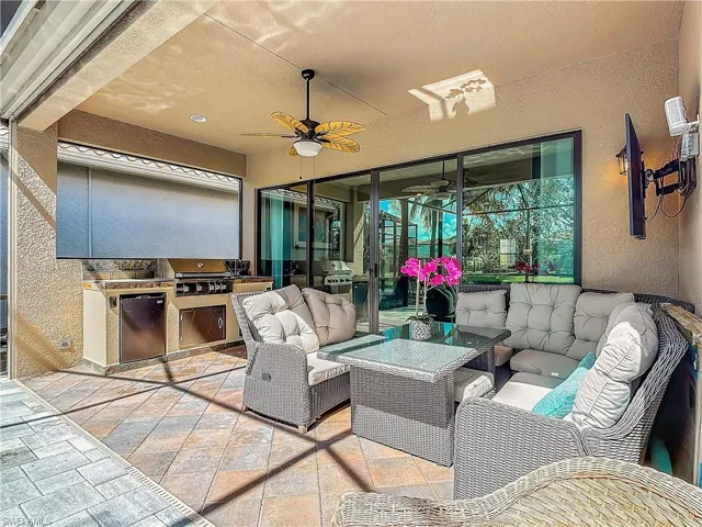 View of patio / terrace featuring area for grilling, ceiling fan, an outdoor hangout area, and a grill