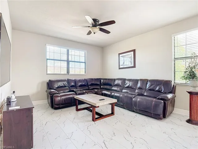 Living room featuring plenty of natural light and ceiling fan