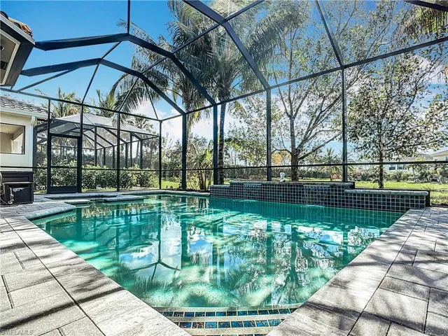 View of swimming pool with a lanai