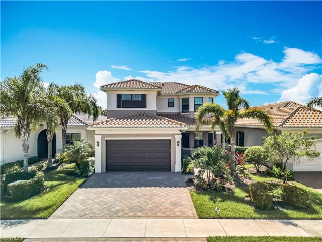 Mediterranean / spanish-style home featuring a garage and a front lawn