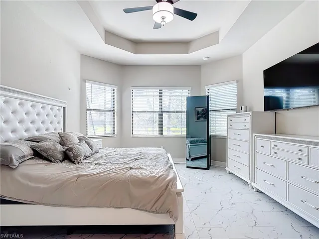 Bedroom featuring ceiling fan and a raised ceiling