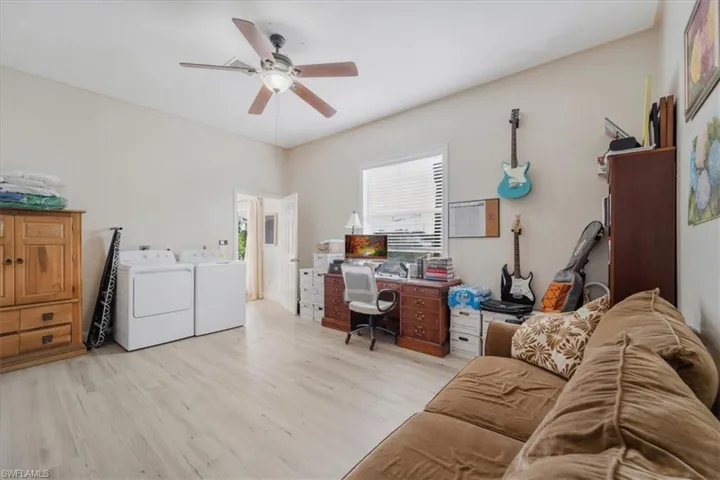 Office featuring light wood-style flooring, independent washer and dryer, and ceiling fan