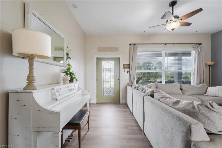 Living area featuring wood finished floors and ceiling fan