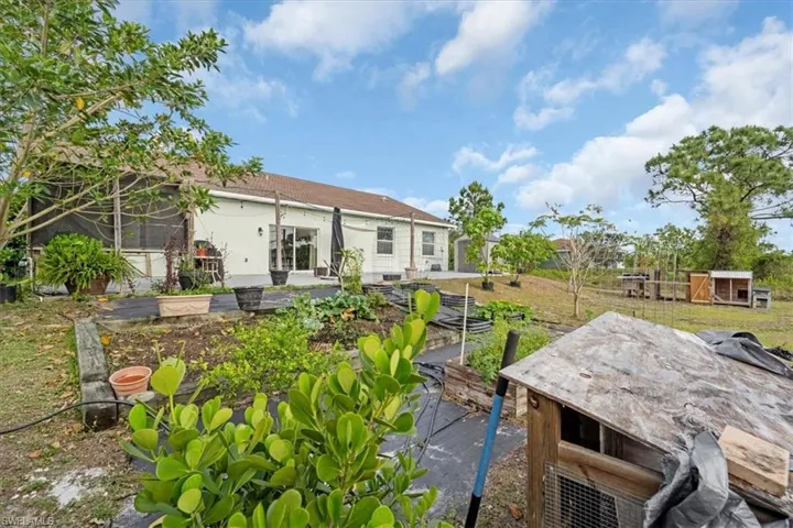 Back of property featuring a garden and a lawn