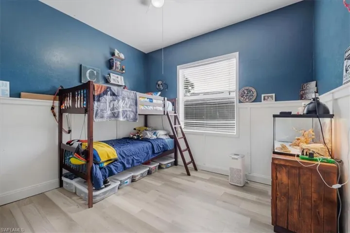 Bedroom featuring baseboards and wood finished floors