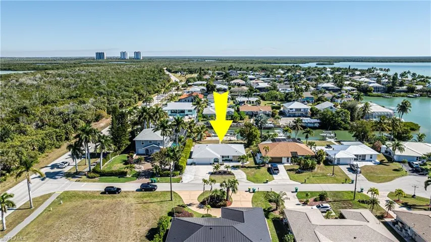 Aerial view of property's location with nearby suburban area and a large body of water