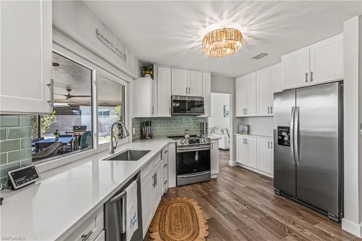 Living area with dark wood-style flooring and ceiling fan