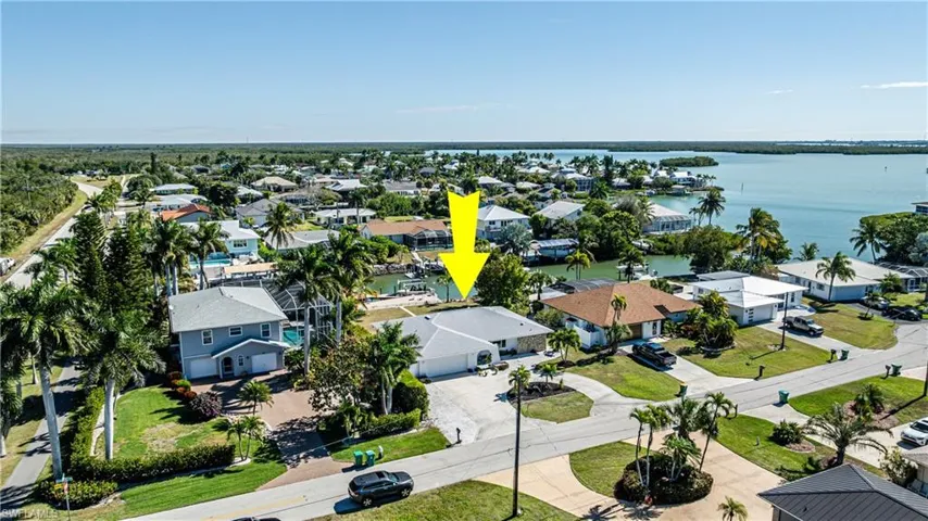 Aerial overview of property's location featuring nearby suburban area and a nearby body of water