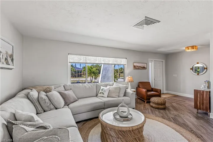 Bedroom with access to outside, wood finished floors, and ceiling fan