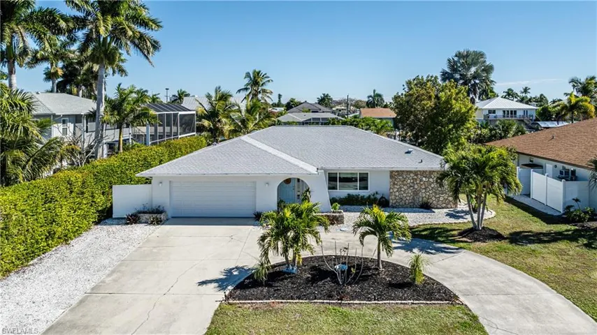 Ranch-style home featuring concrete driveway, an attached garage, stucco siding, and a residential view