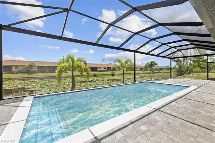 View of swimming pool featuring a lanai and a patio