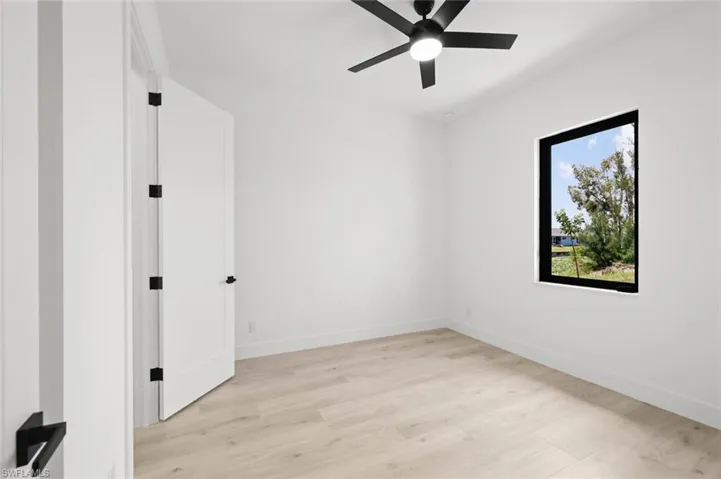 Empty room with light hardwood / wood-style flooring and ceiling fan