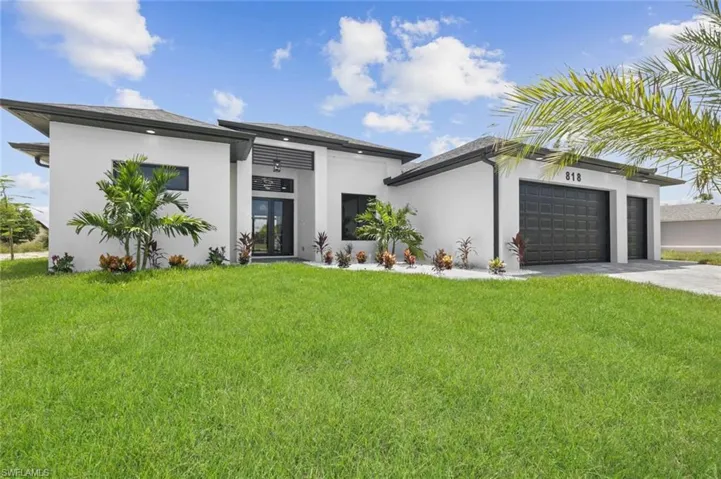 Contemporary home featuring a garage and a front yard