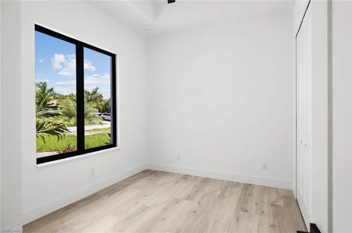 Spare room featuring plenty of natural light and light hardwood / wood-style floors
