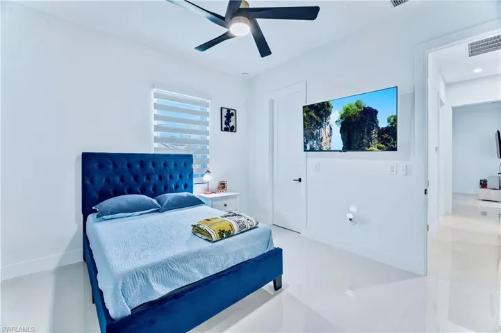 Bedroom with baseboards, ceiling fan, and visible vents