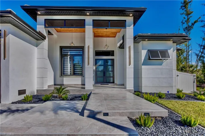 Entrance to property with stucco siding