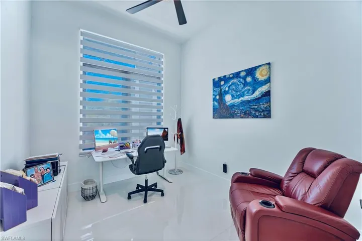 Office with baseboards and a ceiling fan
