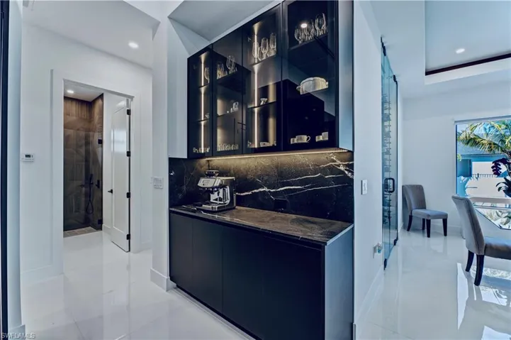 Bar with light tile patterned floors, tasteful backsplash, baseboards, and recessed lighting