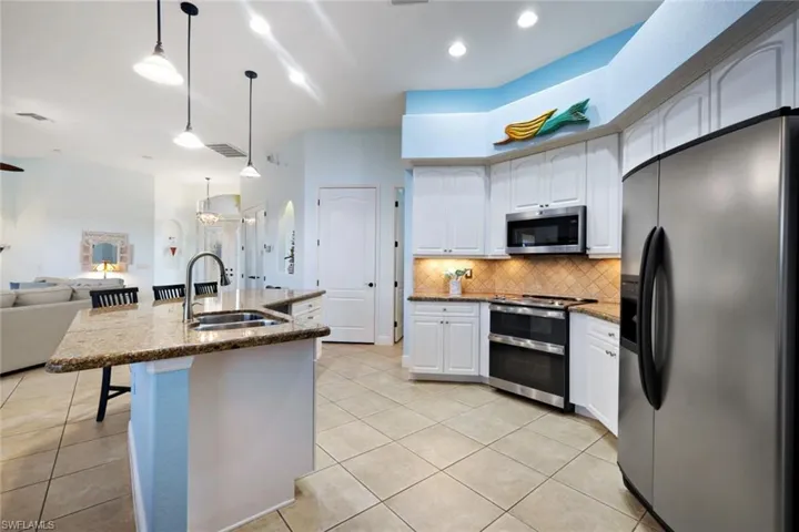 Kitchen featuring decorative backsplash and stainless steal appliances