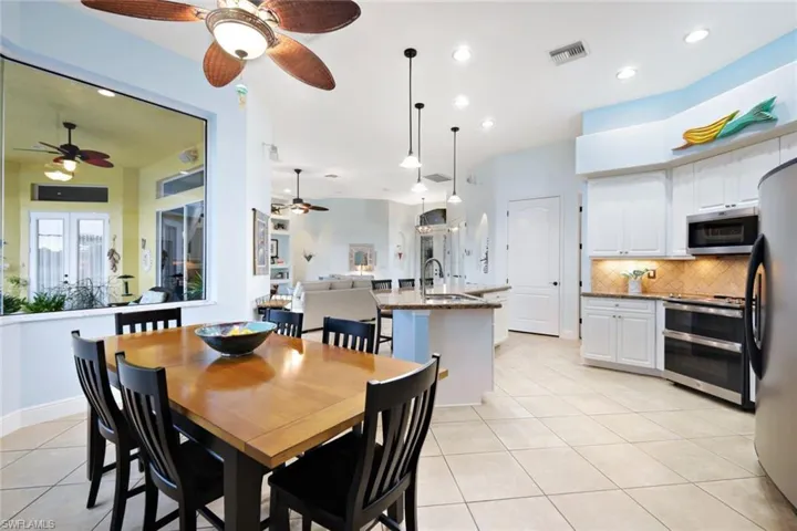 Dining area, featuring a large picture window, has plenty of space for guests.