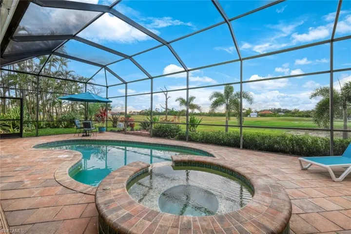 Saltwater pool and spa surrounded by decorative pavers.
