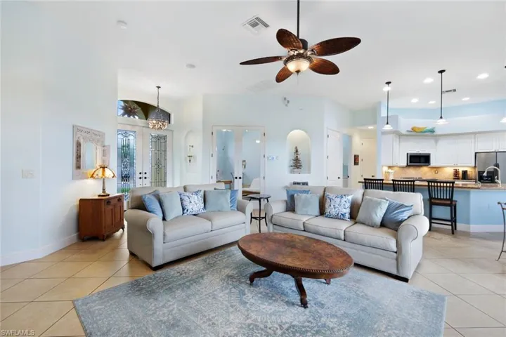 Living room with french doors leading to office/den.