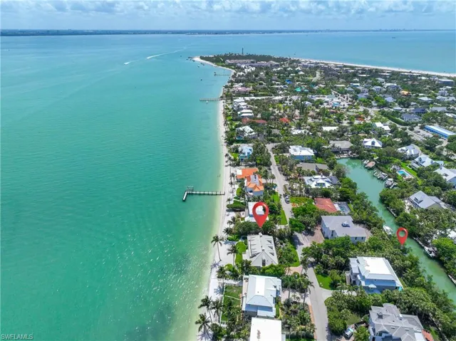 Aerial view of residential area featuring a nearby body of water
