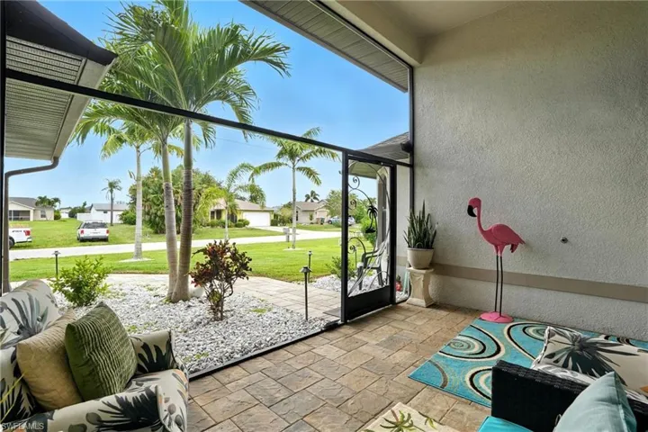 Living area featuring ceiling fan, high vaulted ceiling, and tile patterned flooring