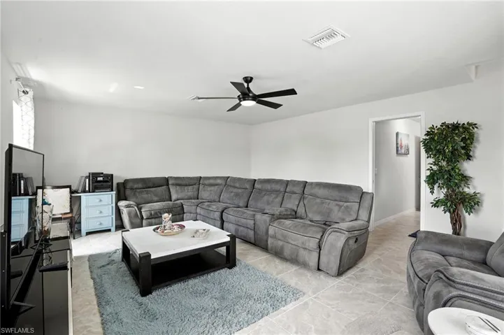Bedroom featuring carpet flooring, multiple windows, and a ceiling fan