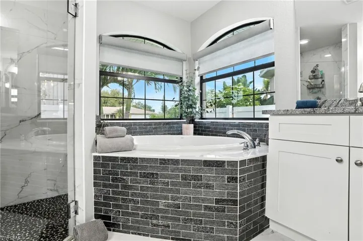 Laundry room with cabinet space, washer and clothes dryer, and a textured ceiling