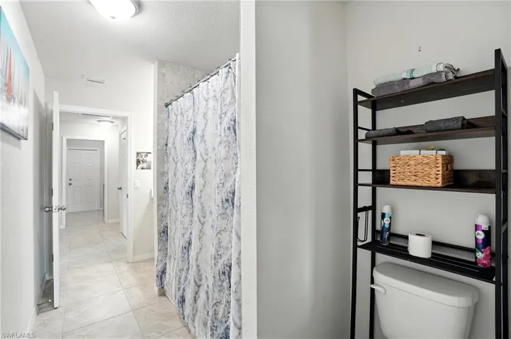 Bathroom featuring vanity, a bath, and a marble finish shower