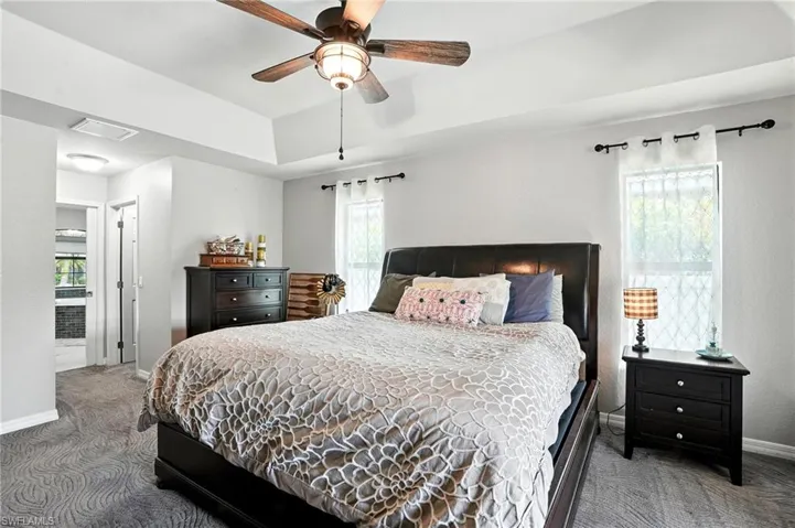 Carpeted bedroom with baseboards and ceiling fan