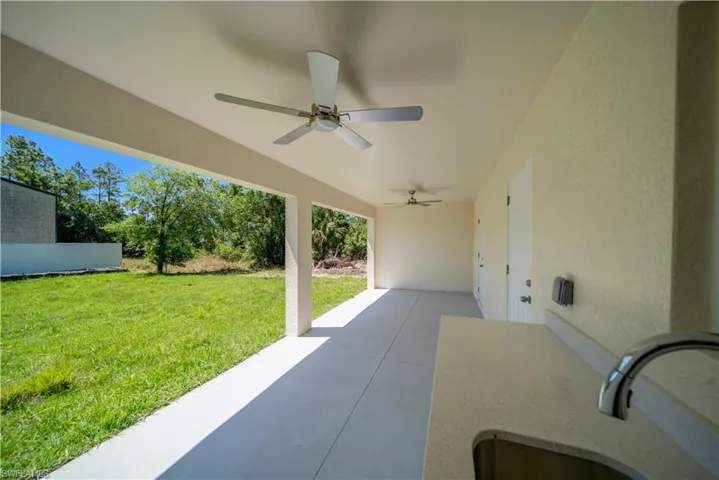 View of patio featuring a ceiling fan and a sink