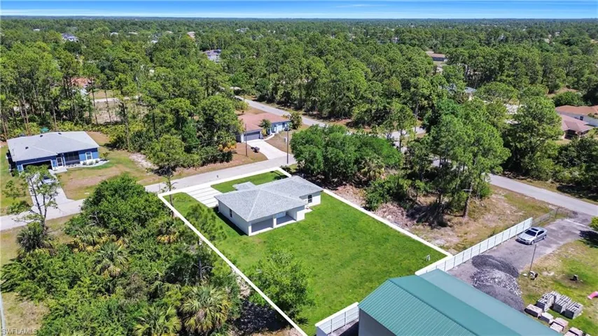 Birds eye view of property with a forest view