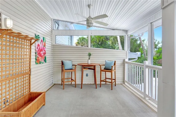 Sunroom featuring ceiling fan and vaulted ceiling