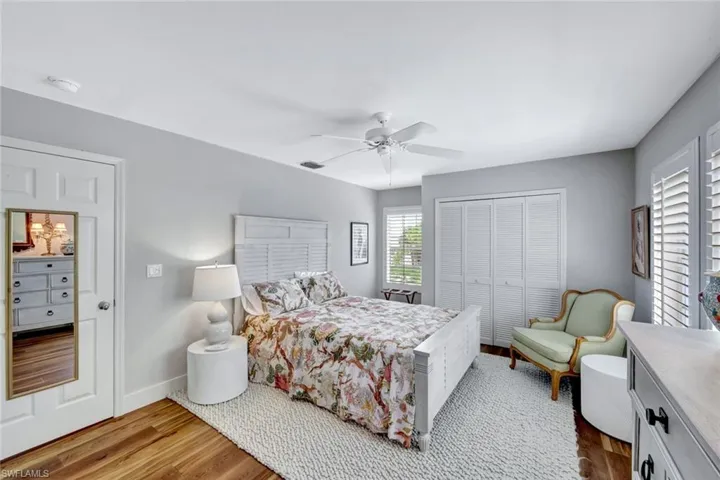 Bedroom featuring a closet, wood finished floors, and ceiling fan