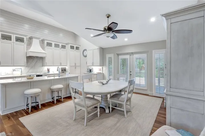 Dining space featuring vaulted ceiling, ceiling fan, wood finished floors, and recessed lighting