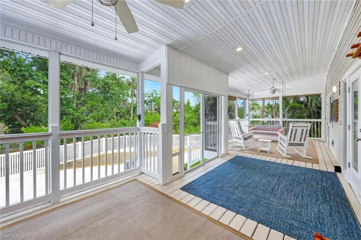 Unfurnished sunroom featuring ceiling fan and plenty of natural light