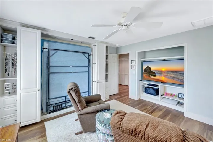 Living room featuring wood finished floors and a ceiling fan