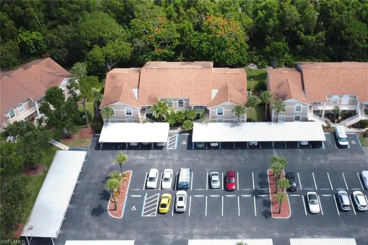 Aerial view of community, showing covered carport; 1 assigned to the condo