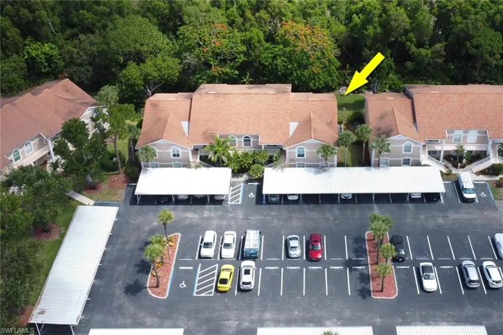 Aerial view of community, showing covered carport; 1 assigned to the condo
