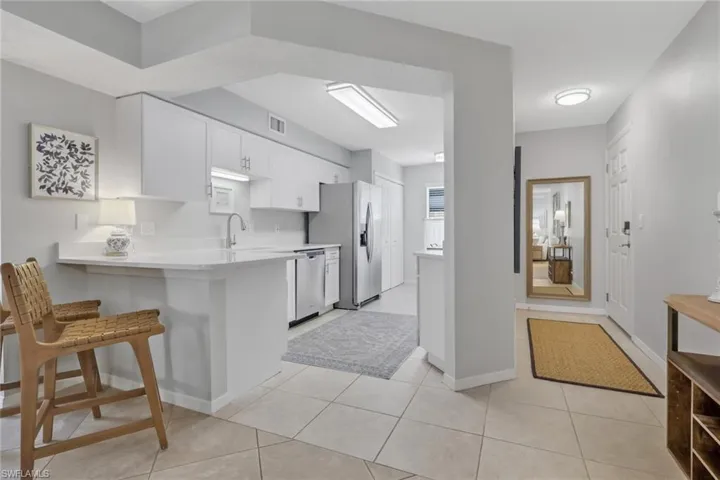 Quartz countertops; entrance to the condo is to the right of the photo