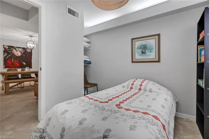 Den area with storage shelving to the rear left