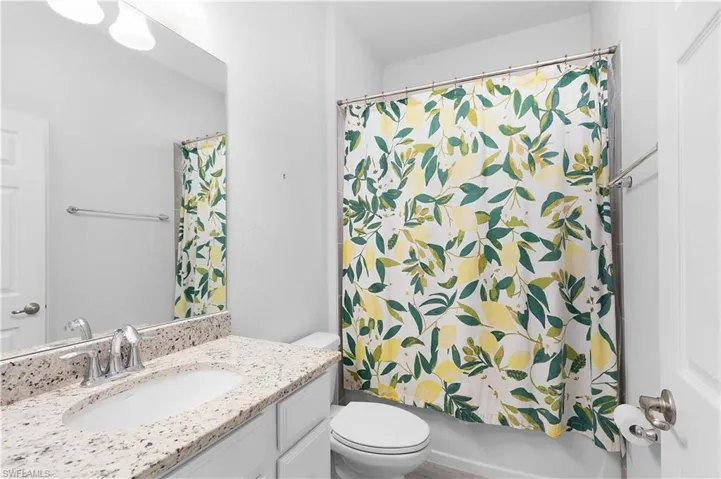 Full bathroom featuring vanity, toilet, and shower / tub combo