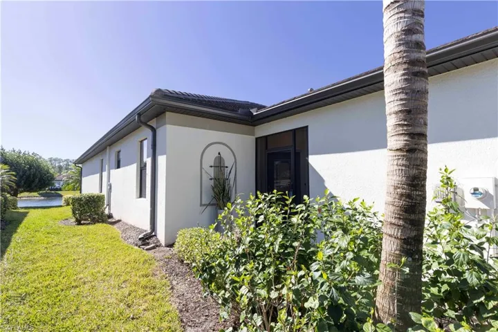 View of side of home with a lawn
