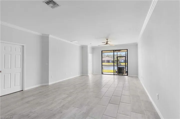 Spare room featuring ceiling fan and ornamental molding
