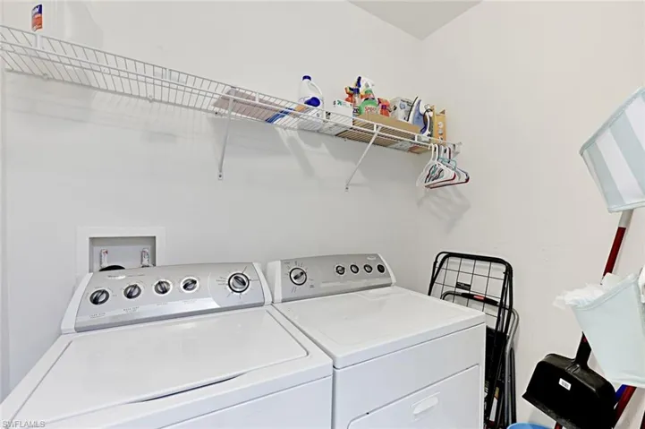 Washroom with washing machine and clothes dryer