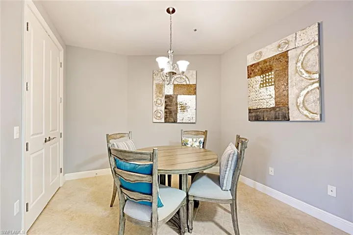Dining room with a chandelier and light tile patterned floors